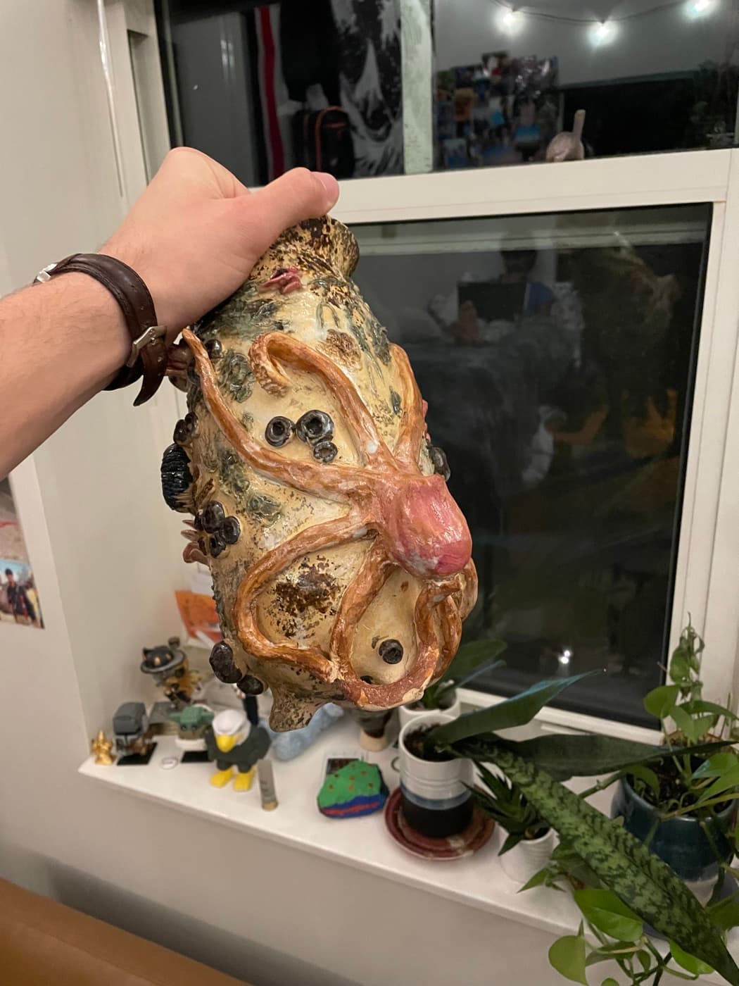 A handmade ceramic vase covered in octopus tentacles